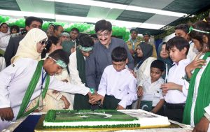 Sindh Chief Minister Syed Murad Ali Shah cuts a cake with differently-abled children to celebrate the upcoming Independence Day at the Marka-e-Haq event held at Quaid-e-Azam House Museum