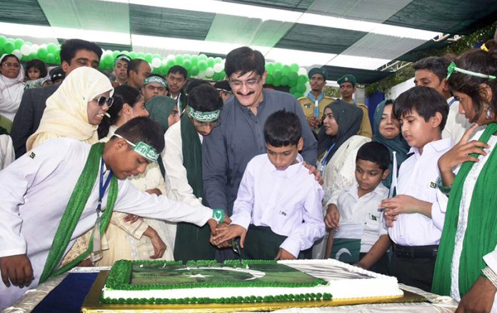 Sindh Chief Minister Syed Murad Ali Shah cuts a cake with differently-abled children to celebrate the upcoming Independence Day at the Marka-e-Haq event held at Quaid-e-Azam House Museum