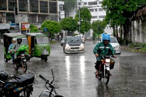Vehicles make their way during the rain in the provincial capital