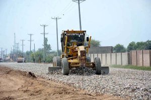 Labourers are busy in construction work of Sargodha Road with the help of heavy machinery during development work in the city.