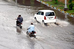 Vehicles make their way during the rain in the provincial capital