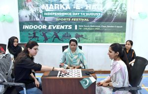 A student makes a decisive move with chess piece during a chess match at the indoor sports festival, held as part of the Pakistan Independence Day and ‘Maarka-e-Haq’ ccelebrations at LUMHS Jamshoro.