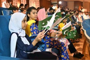 Students present a tableau portraying the partition era and the struggle of Fatima Jinnah, Mother of the Nation, during the Marka-e-Haq and 78th Independence Day celebrations organized by the Workers Welfare Fund at the National Library Auditorium