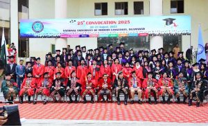 Federal Minister for Education and Professional Training, Dr. Khalid Maqbool Siddiqui, awards a medal to a high-achieving student during the 25th Convocation of NUML