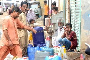 Residents of Korangi area getting water from a hand-pump as the city faces water shortage