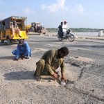 Workers of the local administration mark points to install dynamite near Head Muhammad Wala breaching site as a precautionary measure to divert floodwater in case of a dangerous rise.