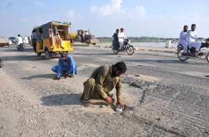 Workers of the local administration mark points to install dynamite near Head Muhammad Wala breaching site as a precautionary measure to divert floodwater in case of a dangerous rise.