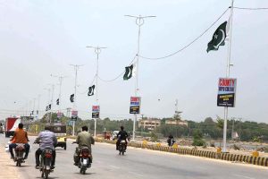 A vendor displaying national flags and another items at Gulshan-e-Sajjad Road to attract the customers in connection with upcoming 78th Independence Day celebration of Pakistan