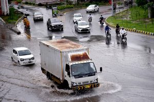 Vehicles make their way during the rain in the provincial capital