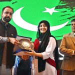 Federal Minister for Overseas Pakistanis and Human Resource Development, Chaudhry Salik Hussain, awarding a shield to young female achiever during the Marka-e-Haq and 78th Independence Day celebrations organized by the Workers Welfare Fund at the National Library Auditorium