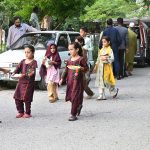 Children from the slum area getting free food distributing by a donor at roadside at F-7 Markaz.