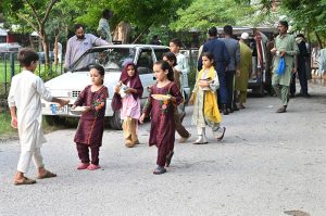 Children from the slum area getting free food distributing by a donor at roadside at F-7 Markaz.
