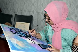 A student busy in calligraphy during a competition held at NAJ art academy Sadiq Colony