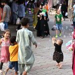 Children enjoying soap bubbles while playing at a weekly bazaar in the G-9, Federal Capital.
