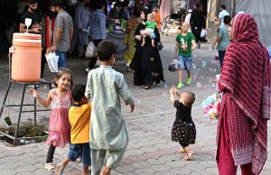 Children enjoying soap bubbles while playing at a weekly bazaar in the G-9, Federal Capital.