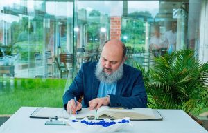 Federal Minister for Commerce, H.E. Jam Kamal Khan, signs the visitors' book during his visit to Square Pharmaceuticals PLC