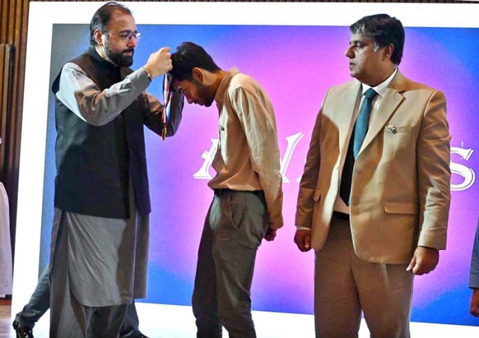 Federal Minister for Overseas Pakistanis and Human Resource Development, Chaudhry Salik Hussain, awarding a gold medal to Abdul Rafay, a student sponsored by the Workers Welfare Fund (WWF), for his historic achievement of winning Pakistan’s first-ever gold medal at the prestigious 36th International Biology Olympiad (IBO) held in the Philippines from July 21 to 27, 2025
