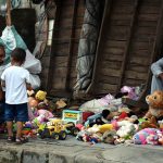A vendor displays toys along the roadside to attract customers in the city