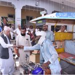 Federal Minister for Board of investment, Qaiser Ahmad Sheikh, distributing 5 liter free petrol slips to the motorcycle rickshaw drivers during the celebration of Independence Day celebrations.