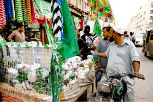 People shop for decorative items for Eid Milad-un-Nabi celebrations at Paper Market