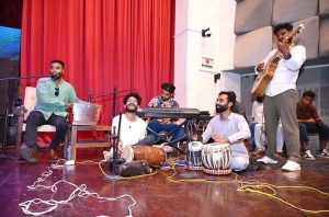 A local musical band performs on stage during Minority Day and Independence Day celebrations organized by Hum Log Organization at Nishtar Hall.