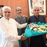 Former President of the Chamber of Commerce, Sheikh Tahir Majeed, congratulates Defense Minister Khawaja Muhammad Asif on receiving the Sitara-e-Imtiaz by presenting him with a bouquet of flowers
