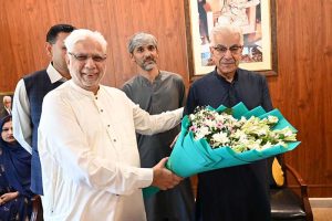 Former President of the Chamber of Commerce, Sheikh Tahir Majeed, congratulates Defense Minister Khawaja Muhammad Asif on receiving the Sitara-e-Imtiaz by presenting him with a bouquet of flowers