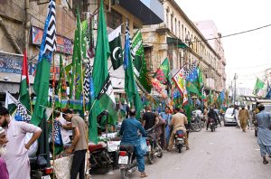 People shop for decorative items for Eid Milad-un-Nabi celebrations at Paper Market