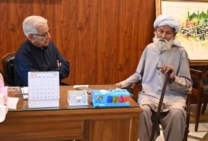 Defence Minister Khawaja Muhammad Asif listens to the problems of people from his constituency at his residence in Cantt