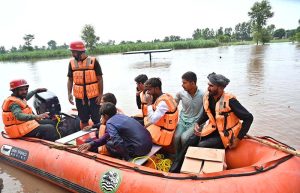 Residents wade through floodwater while evacuating to safer places after Mid Ranjha was inundated, as rivers swelled above dangerous levels due to heavy rains and the opening of Indian floodgates.