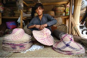 A youngster crafting traditional caps at his workplace near Dabgari area.