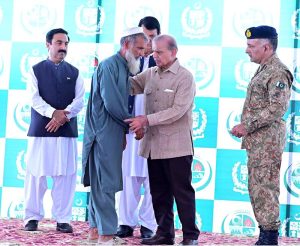 Prime Minister Muhammad Shehbaz Sharif distributing relief cheques among the victims of the recent torrential rains and floods in Buner