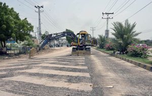 A heavy machinery being used to break road during repairing work of Autobahn Road