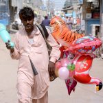 A vendor sells balloons at the Korangi area