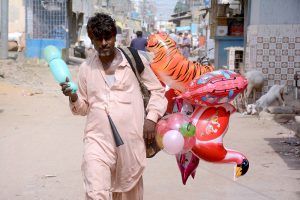 A vendor sells balloons at the Korangi area