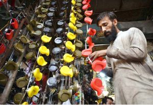 A vendor displaying vehicle pressure horns for sell to attract customers at Shoba Bazaar.