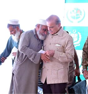 Prime Minister Muhammad Shehbaz Sharif distributing relief cheques among the victims of the recent torrential rains and floods in Buner