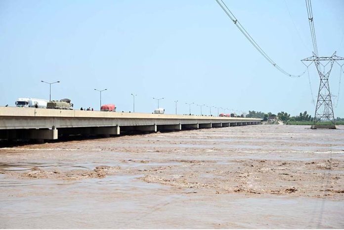 A view of floodwater from the River Chenab crossing dangerous levels at Talibwala Bridge, inundating several areas of Punjab following heavy rains and the opening of floodgates by India