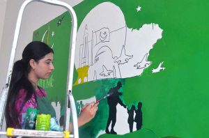 Students paint a wall at Central Jail Hyderabad as part of "Jashan-e-Marka-e-Haq" and Independence Day celebrations ahead of Pakistan’s 78th Independence Day.