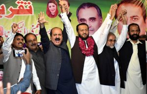 Chairman Prime Minister’s Youth Programme, Rana Mashhood Ahmad Khan, along with PML-N candidate for NA-129 Lahore, Hafiz Mian Nouman, making a hand chain and showing a victory sign during a by-election campaign gathering.