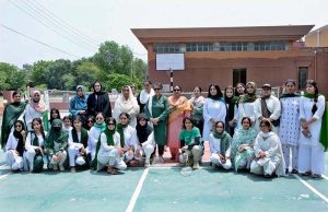 Student badminton players in action during a match organized by the Government College Women University Faisalabad (GCWUF) to mark Independence Day and Marka-e-Haq