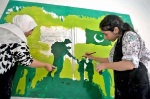 Students paint a wall at Central Jail Hyderabad as part of "Jashan-e-Marka-e-Haq" and Independence Day celebrations ahead of Pakistan’s 78th Independence Day.