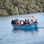 A family enjoying a boat ride at Native Jetty on the Arabian Sea during hot weather.