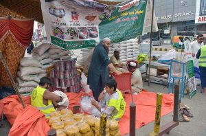 Pakistan Markazi Muslim League (PMML) party volunteers camp in Saddar bazar as they sort food rations to be sent to people who affected by flooding in KPK.