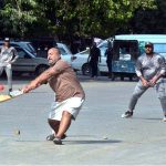 Youngsters playing cricket on a road in the Saddar area during the holiday.