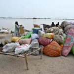 Flood-affected residents of Nizam Kalhoro village in the Kachha area of the Indus River shift their belongings to safer places after the district administration issued a flood warning