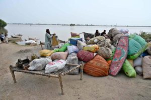 Flood-affected residents of Nizam Kalhoro village in the Kachha area of the Indus River shift their belongings to safer places after the district administration issued a flood warning