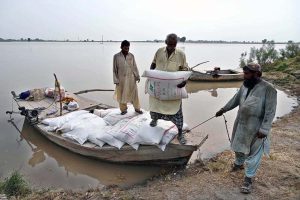 Flood-affected residents of Nizam Kalhoro village in the Kachha area of the Indus River shift their belongings to safer places after the district administration issued a flood warning