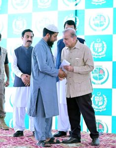 Prime Minister Muhammad Shehbaz Sharif distributing relief cheques among the victims of the recent torrential rains and floods in Buner