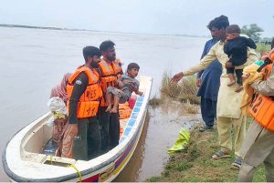 Rescue 1122 helping people to evacuate the flood area to safer place. 900000 cusec flood water crossing the area in River Chenab